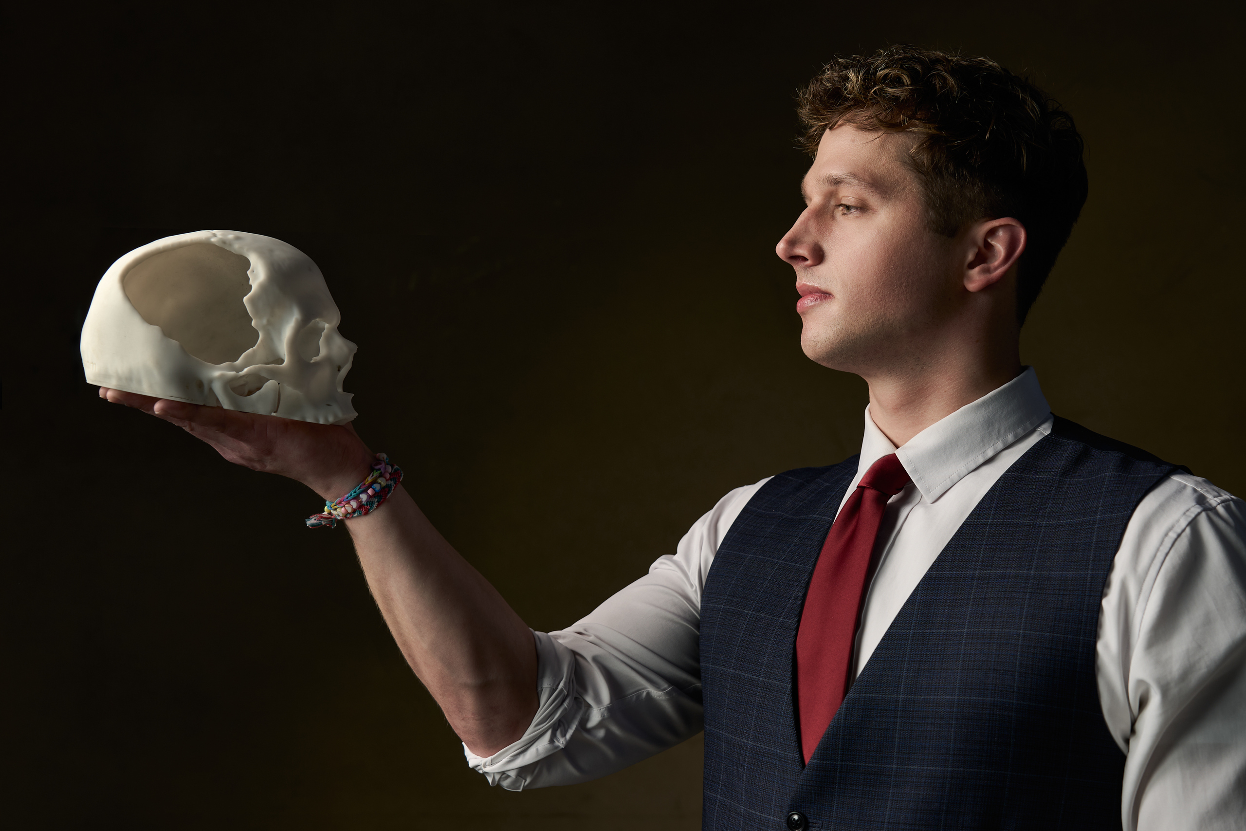 Cameron Michael Fathauer holding a model of his skull